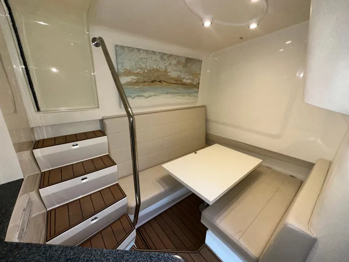 Wooocrew Yacht Photos Pics 2015 SeaVee 43 Fish-Around interior with cozy seating and table, featuring elegant wood flooring.