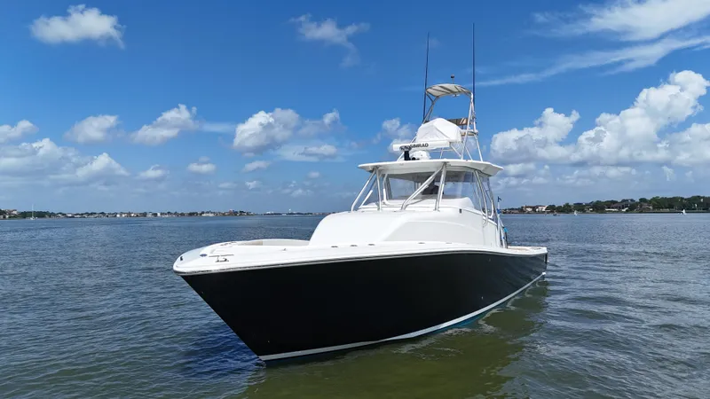 Wooocrew Yacht Photos Pics 2015 SeaVee 43 Fish-Around boat on calm water under blue sky.