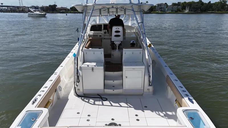 Wooocrew Yacht Photos Pics 2015 SeaVee 43 Fish-Around boat on water, featuring spacious deck and helm.