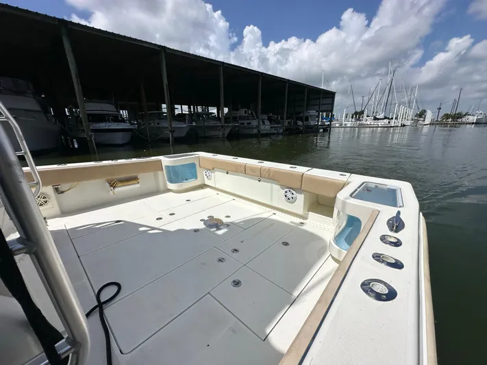Wooocrew Yacht Photos Pics 2015 SeaVee 43 Fish-Around boat docked, spacious deck, marina background, partly cloudy sky.
