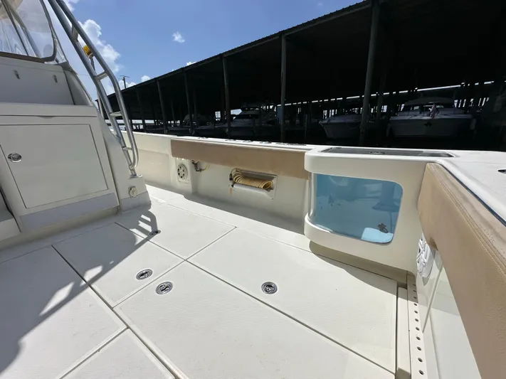 Wooocrew Yacht Photos Pics 2015 SeaVee 43 Fish-Around boat deck with storage and seating under sunny sky.