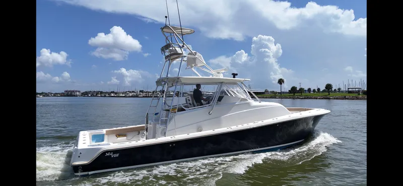 Wooocrew Yacht Photos Pics 2015 SeaVee 43 Fish-Around boat cruising on a sunny day with blue skies.