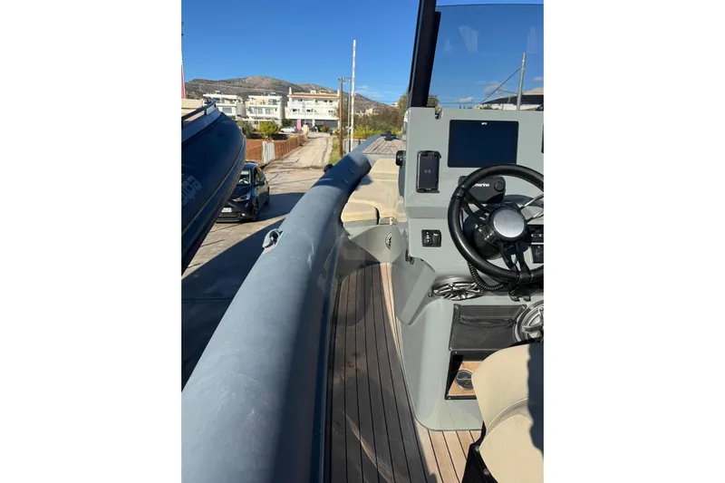  Yacht Photos Pics 2023 Rock Marine ROCK 30 boat interior with steering wheel and control panel.