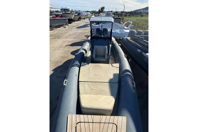  Yacht Photos Pics 2023 Rock Marine ROCK 30 boat with cushioned seating, docked outdoors.