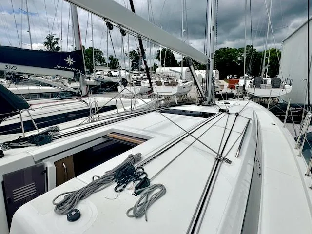 410 #345 In Stock Yacht Photos Pics 2024 Jeanneau Sun Odyssey 410 sailboat docked in marina, showcasing sleek deck design.