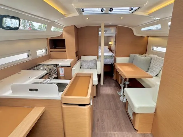 410 #345 In Stock Yacht Photos Pics 2024 Jeanneau Sun Odyssey 410 interior, featuring modern kitchen and cozy seating area.