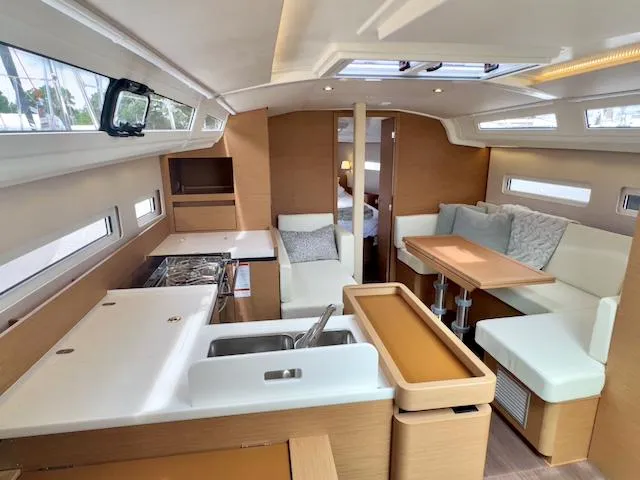 410 #345 In Stock Yacht Photos Pics 2024 Jeanneau Sun Odyssey 410 interior with modern kitchen and cozy seating area.