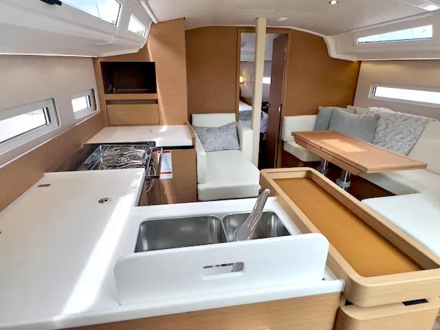 410 #345 In Stock Yacht Photos Pics 2024 Jeanneau Sun Odyssey 410 interior with modern kitchen and cozy seating area.