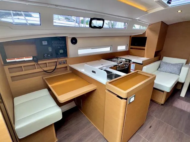 410 #345 In Stock Yacht Photos Pics Interior of 2024 Jeanneau Sun Odyssey 410 sailboat with modern kitchen and seating area.