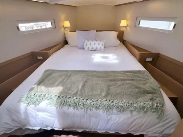410 #345 In Stock Yacht Photos Pics Luxurious bedroom interior of 2024 Jeanneau Sun Odyssey 410 yacht with cozy bedding.