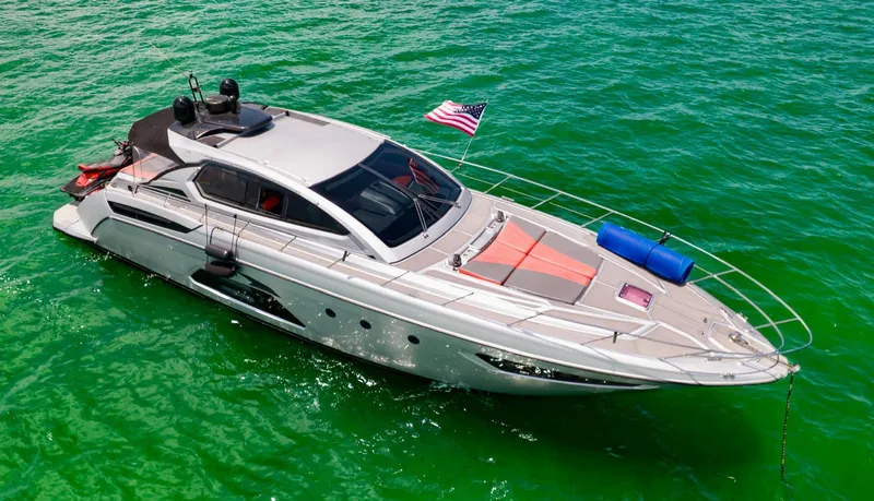 D Padron Yacht Photos Pics 2013 Azimut Atlantis 58 yacht on vibrant green water, featuring sleek design and American flag.