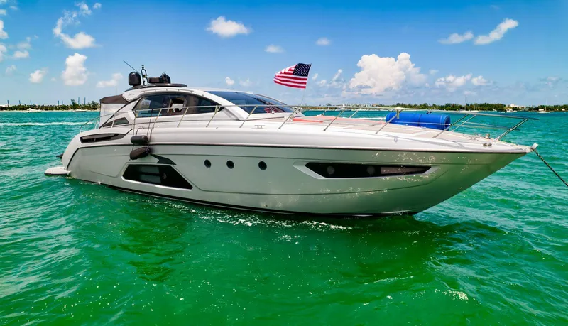 D Padron Yacht Photos Pics Azimut Atlantis 58 yacht, 2013 model, cruising in turquoise waters under a clear blue sky.