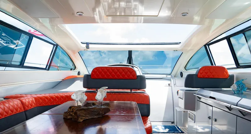 D Padron Yacht Photos Pics Luxurious interior of 2013 Azimut Atlantis 58 yacht with red seating and panoramic windows.