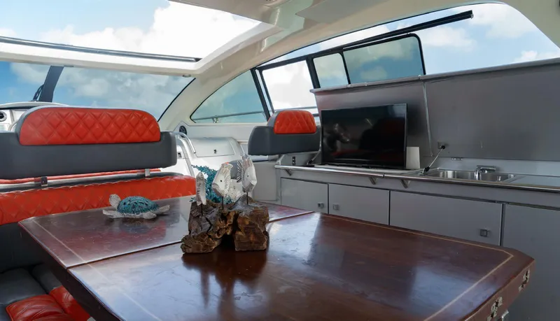 D Padron Yacht Photos Pics Luxurious interior of 2013 Azimut Atlantis 58 yacht with red seating and wooden table.