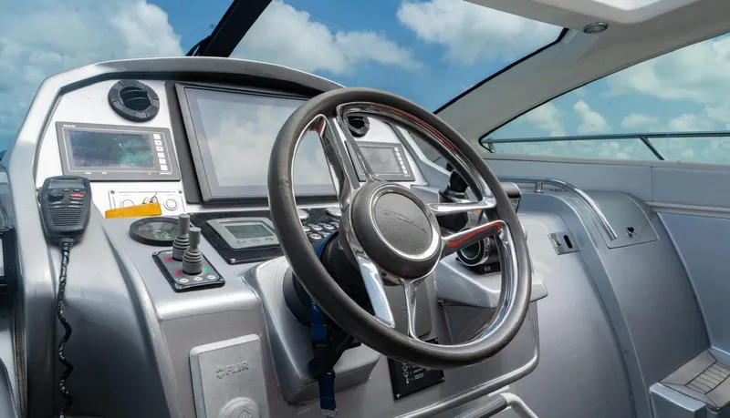 D Padron Yacht Photos Pics Cockpit of 2013 Azimut Atlantis 58 yacht with steering wheel and navigation controls.