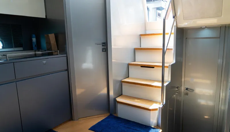 D Padron Yacht Photos Pics Interior of 2013 Azimut Atlantis 58 yacht, featuring modern stairs and sleek cabinetry.