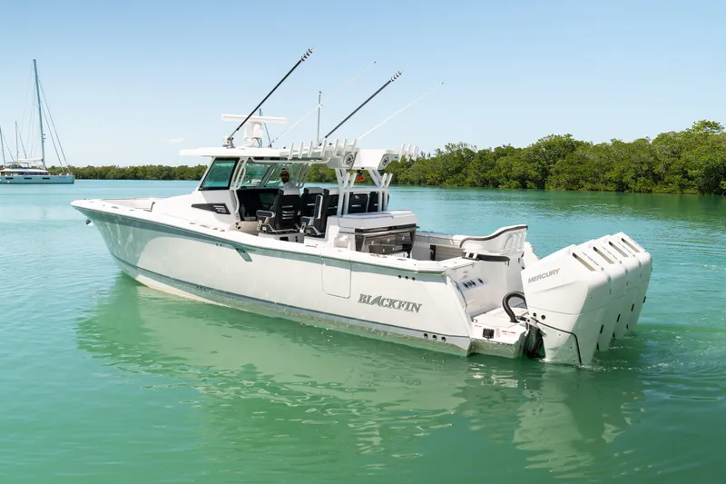  Yacht Photos Pics 2024 Blackfin 400 CC boat on calm water, featuring sleek design and powerful engines.