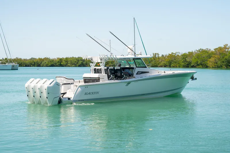  Yacht Photos Pics 2024 Blackfin 400 CC boat on calm water, featuring multiple outboard engines.