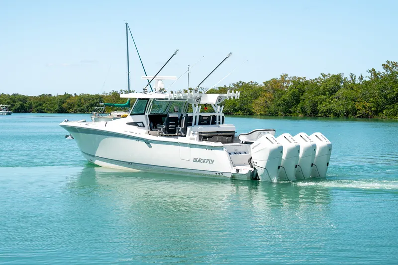  Yacht Photos Pics 2024 Blackfin 400 CC boat cruising on a serene blue lake.