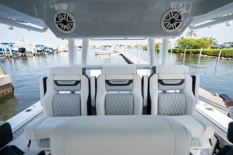  Yacht Photos Pics 2024 Blackfin 400 CC boat interior with luxurious seating and waterfront view.