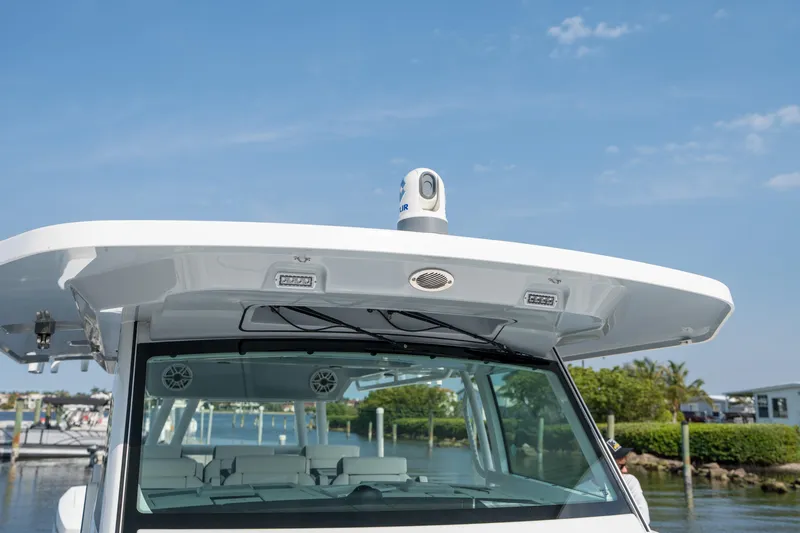  Yacht Photos Pics 2024 Blackfin 400 CC boat with advanced navigation equipment, docked under a clear blue sky.