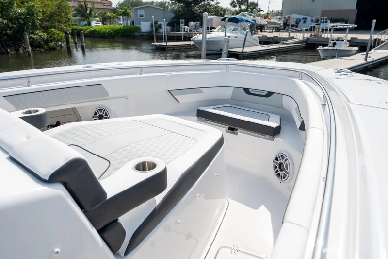  Yacht Photos Pics 2024 Blackfin 400 CC boat interior with seating and cup holders at a marina.
