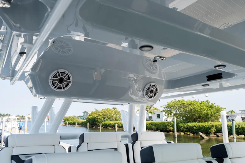  Yacht Photos Pics 2024 Blackfin 400 CC boat interior with speakers and seating, dockside view.