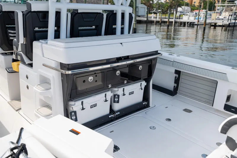  Yacht Photos Pics 2024 Blackfin 400 CC boat interior with storage compartments and seating, docked at marina.