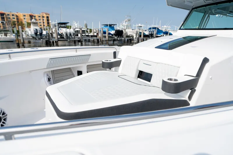  Yacht Photos Pics 2024 Blackfin 400 CC boat interior with seating and cup holders at marina.