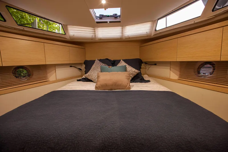 Soteria Yacht Photos Pics Luxurious cabin interior of 2017 Greenline 40 Hybrid Yacht with cozy bedding and natural light.