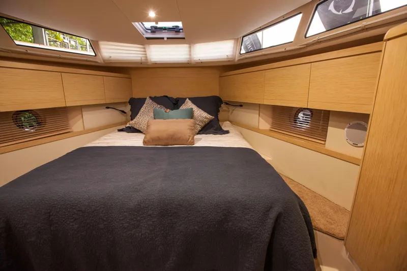 Soteria Yacht Photos Pics Luxurious cabin interior of 2017 Greenline 40 Hybrid Yacht with cozy bedding and wood finish.