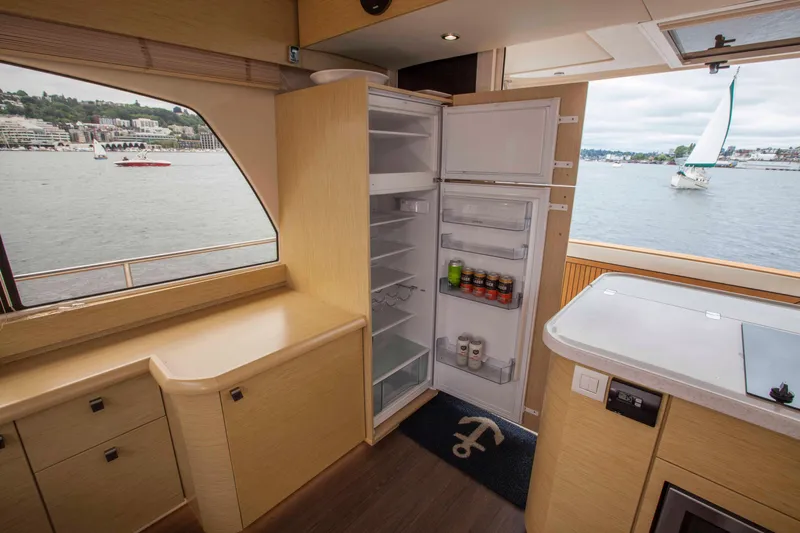 Soteria Yacht Photos Pics Interior of 2017 Greenline 40 Hybrid Yacht with open fridge, overlooking water.