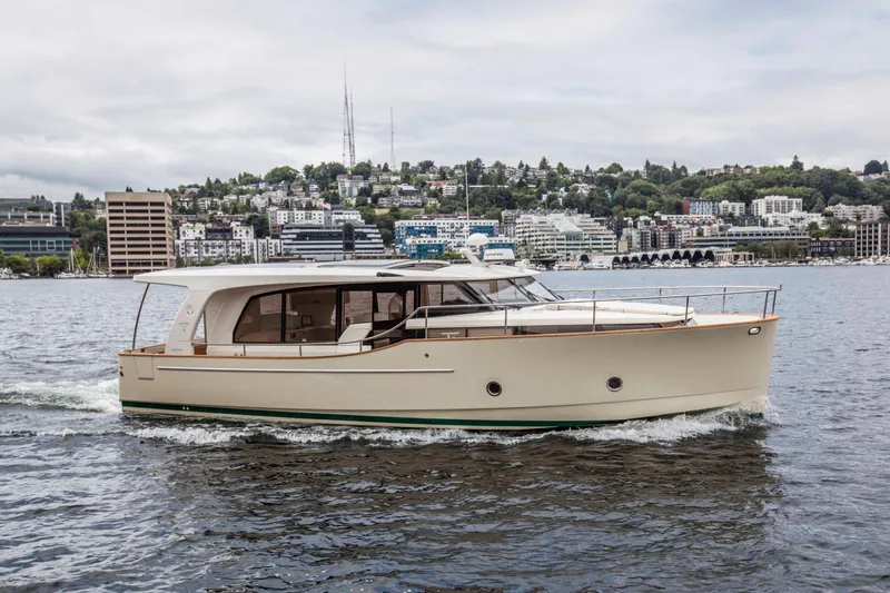 Soteria Yacht Photos Pics 2017 Greenline 40 Hybrid Diesel/Electric Yacht cruising on a scenic waterfront.