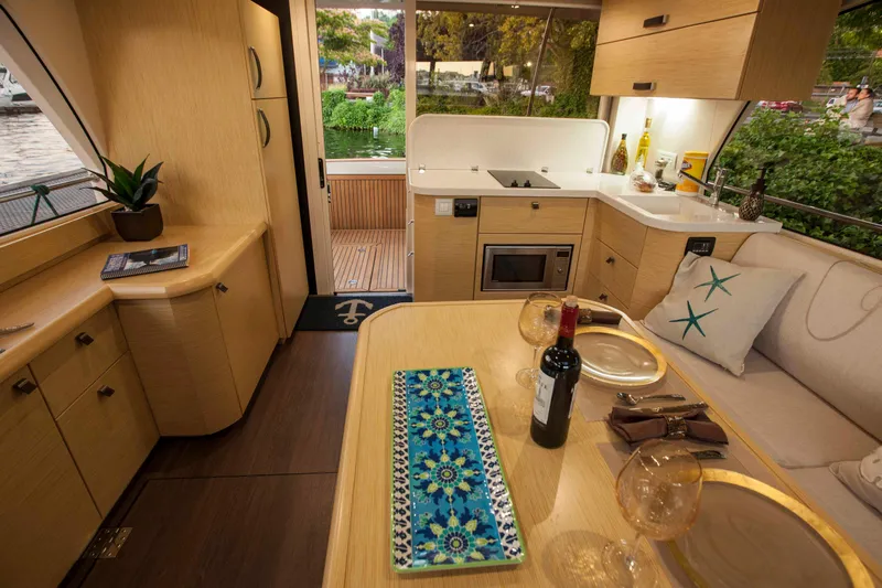 Soteria Yacht Photos Pics Luxurious interior of 2017 Greenline 40 Hybrid Yacht with modern kitchen and dining area.