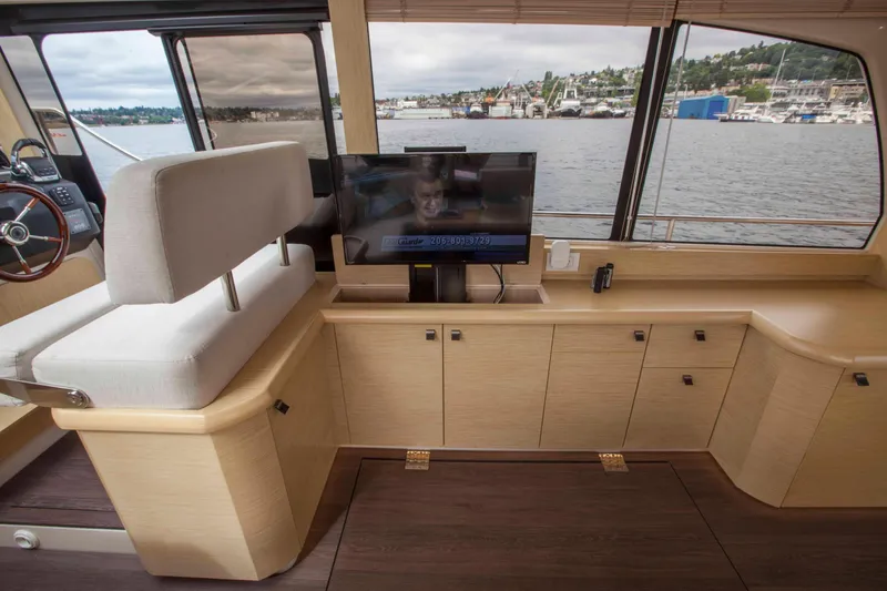 Soteria Yacht Photos Pics 2017 Greenline 40 Hybrid Yacht interior with TV, cabinets, and scenic water view.