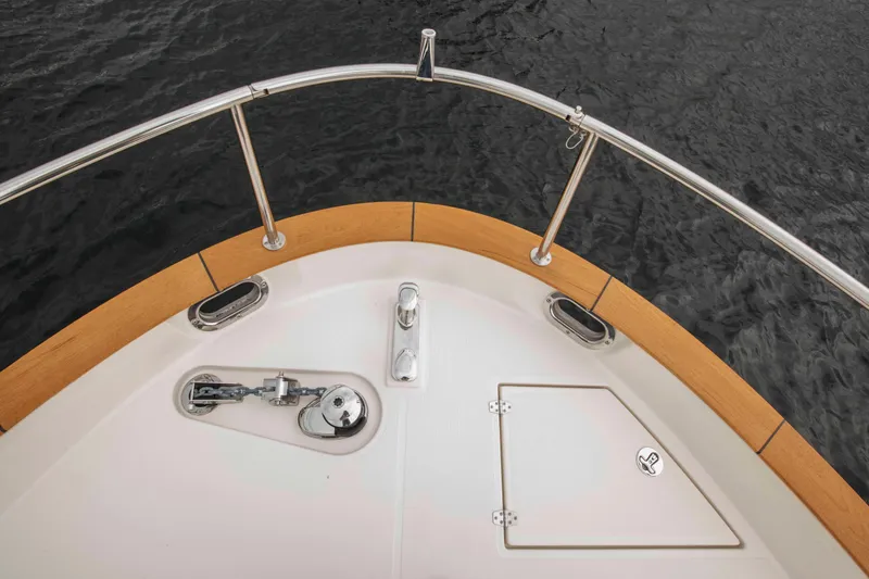 Soteria Yacht Photos Pics Bow of 2017 Greenline 40 Hybrid Yacht with anchor and hatch, on calm water.