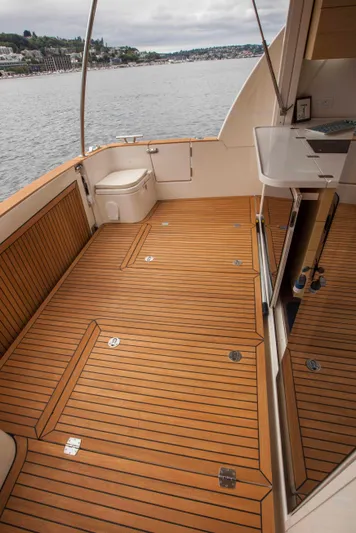 Soteria Yacht Photos Pics 2017 Greenline 40 Hybrid Yacht deck with wood finish, overlooking calm waters.