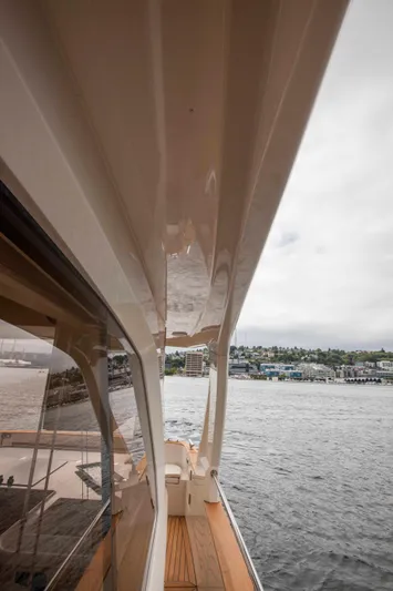 Soteria Yacht Photos Pics 2017 Greenline 40 Hybrid Yacht on water, showcasing sleek design and wooden deck.