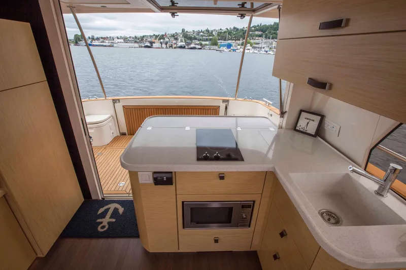 Soteria Yacht Photos Pics Interior of 2017 Greenline 40 Hybrid Yacht with kitchen and scenic water view.