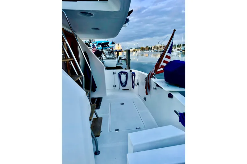 Kokomo Yacht Photos Pics 1997 Ocean Alexander 426 Classico yacht deck with American flag, docked at marina.