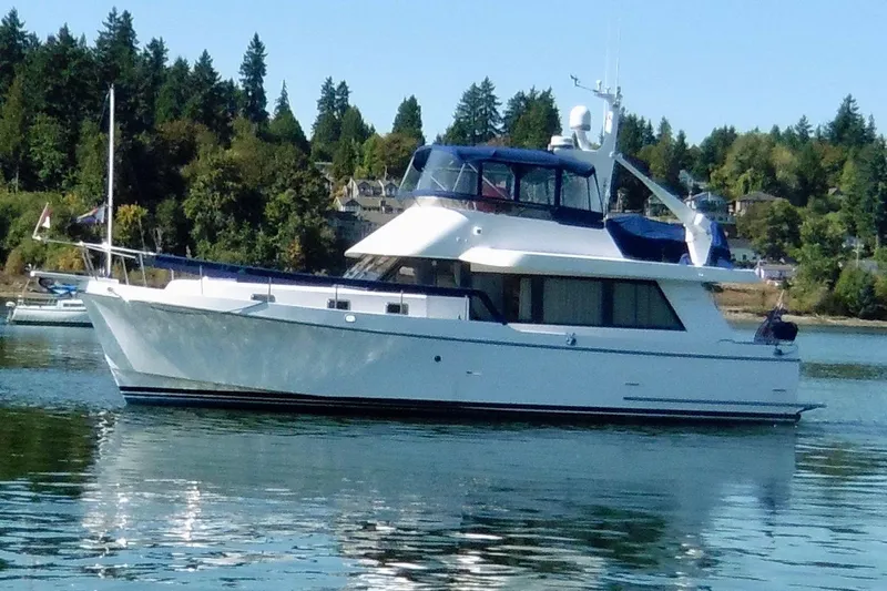 Kokomo Yacht Photos Pics 1997 Ocean Alexander 426 Classico yacht on calm water with forested background.