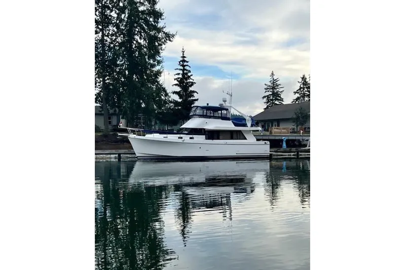 Kokomo Yacht Photos Pics 1997 Ocean Alexander 426 Classico yacht docked on calm water, surrounded by trees.