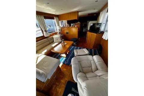 Kokomo Yacht Photos Pics Interior of 1997 Ocean Alexander 426 Classico yacht with cozy seating and wooden accents.