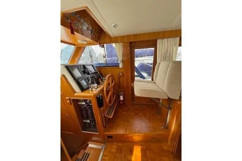 Kokomo Yacht Photos Pics 1997 Ocean Alexander 426 Classico helm with wooden steering wheel and navigation instruments.