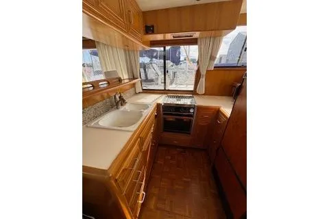 Kokomo Yacht Photos Pics 1997 Ocean Alexander 426 Classico yacht kitchen with wood cabinetry and modern appliances.