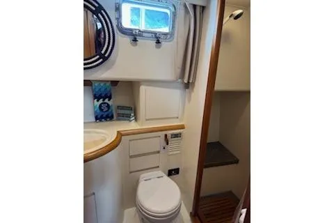 Kokomo Yacht Photos Pics Bathroom interior of 1997 Ocean Alexander 426 Classico yacht, featuring toilet and porthole window.