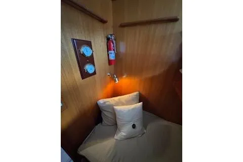 Kokomo Yacht Photos Pics Cozy cabin interior of 1997 Ocean Alexander 426 Classico with wooden paneling and fire extinguisher.