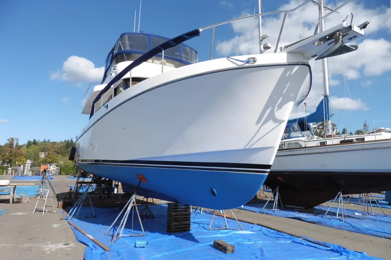 Kokomo Yacht Photos Pics 1997 Ocean Alexander 426 Classico Sedan yacht on dry dock, blue hull, clear sky.