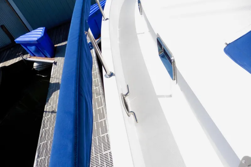 Kokomo Yacht Photos Pics Ocean Alexander 423 Classico 2000 yacht deck with blue railings and dock view.