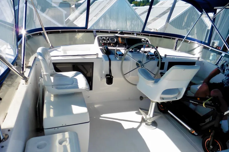 Kokomo Yacht Photos Pics Cockpit of 2000 Ocean Alexander 423 Classico yacht with steering wheel and seating.